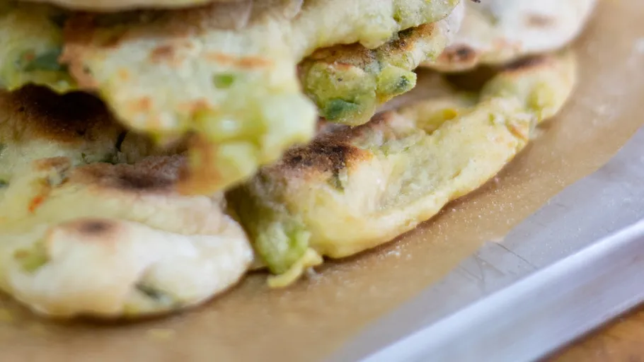 Stacks of flat, browned bread on baking paper.