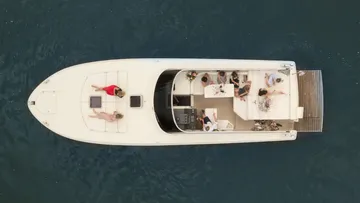 People relaxing on a yacht in water.