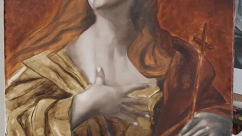A woman with reddish hair is holding a stick.