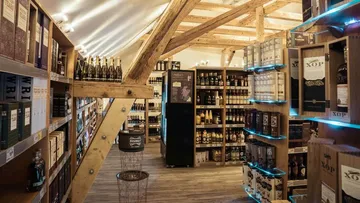 Shelf with spirits, light accentuated, rustic atmosphere.