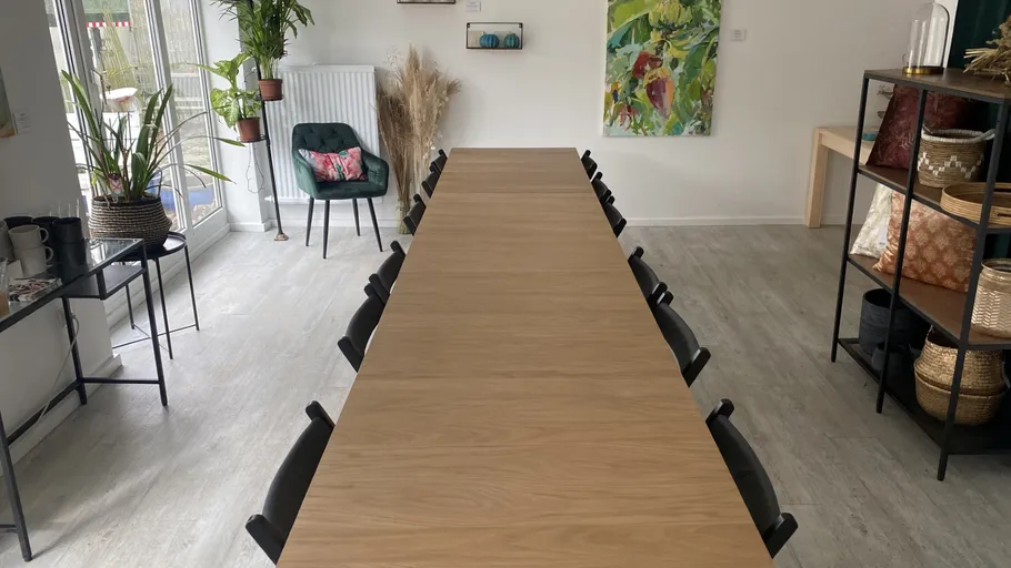 A long table is empty in a bright room.