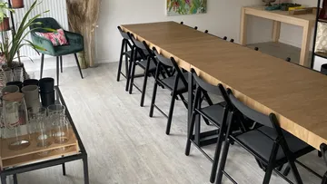 Long table with chairs in a bright room.