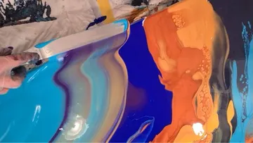 Colored resin is worked with a spatula, creative design.