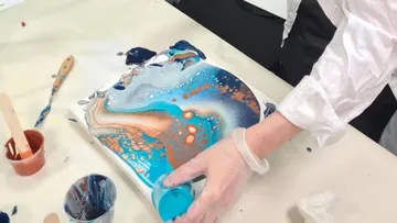 Colourfully painted canvas is processed with paint.