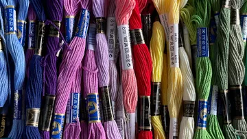 Threads of different colors are arranged next to each other.
