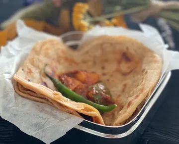 Flatbread wraps a spicy mixture in a bowl.