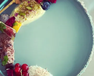 Elegant dessert with fruits on blue plate