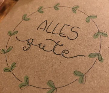 Card with the text 'ALL GOOD' and green leaves.