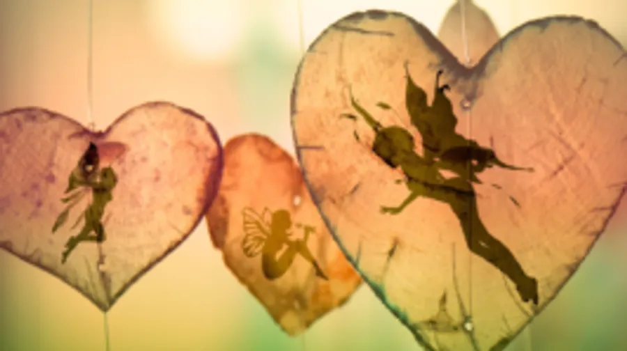 Hearts with fairy motifs hang softly in the light.