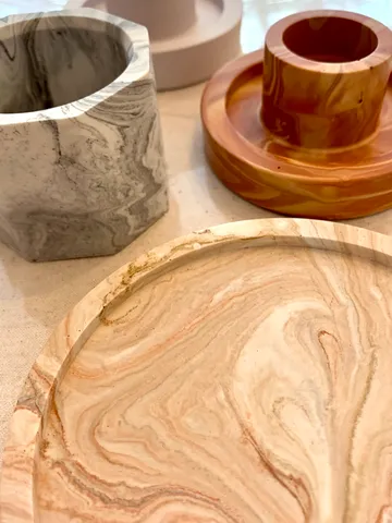 Bowls made of various materials lie on a table.