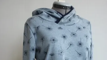 Grey hoodie with dandelion print on mannequin.