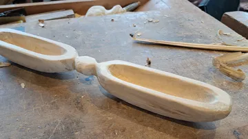 Wooden bowl is lying on the workshop table, unfinished.