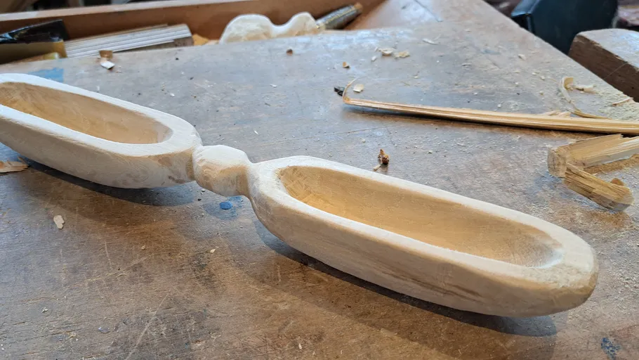 Wooden bowl is lying on the workshop table, unfinished.