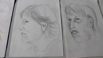 Two portraits of women, side view, drawn on paper.
