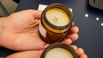 Two candles in hands, ready to light