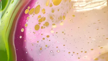 Colourful liquid with bubble-like structures on a smooth surface.