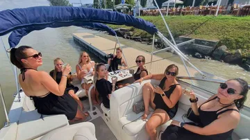 Women party on a boat, drink cocktails, sunny.