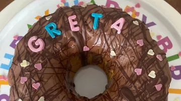 Circular donut decorated with chocolate and colorful letters