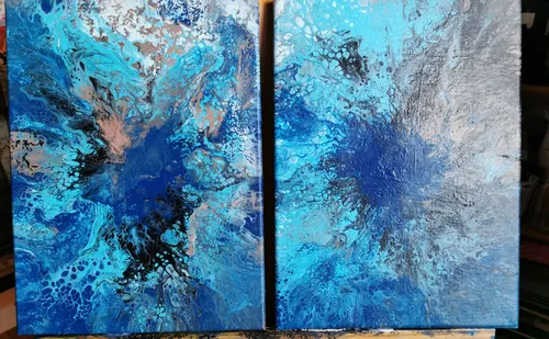 Two canvases with blue, abstract color patterns.