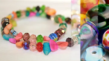 Colourful pearl necklace lies on a white background.
