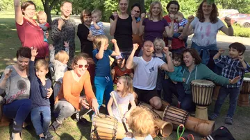 Group dance with children and adults in the park.