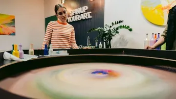 Woman observes color runners in a creative studio.