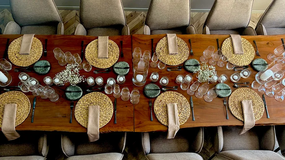 A set table with plates, glasses and decoration.
