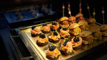 Gourmet appetizers on a tray, decorated and served