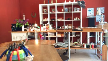 Workshop with tables, presents jewelry and craft materials.