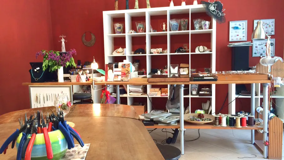 Workshop with tables, presents jewelry and craft materials.
