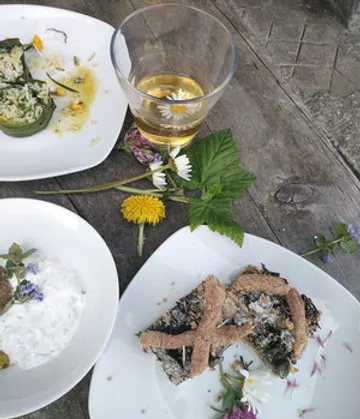 Two plates of special food and a glass of drink.