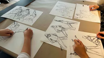 Drawings are made on paper by several people.