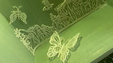 Butterflies and flowers are delicate on a green background.