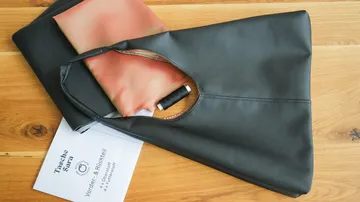 Black bag with orange fabric and instructions next to it.