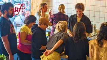 Group of people working together in a kitchen.