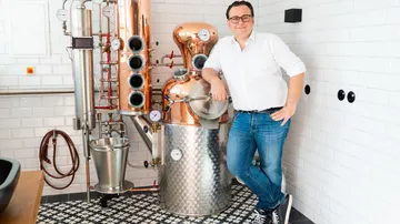 There is a copper distiller in a modern kitchen.