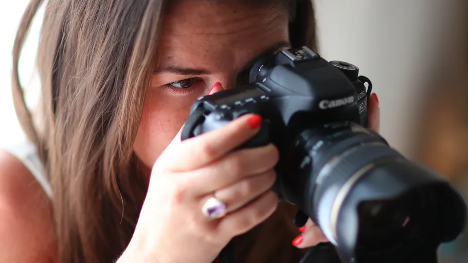 Person holding camera, taking photograph.