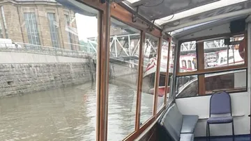 Ein Boot fährt im Hafen neben anderen Booten.