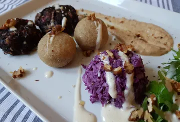 Various vegetarian dishes served on a white plate.