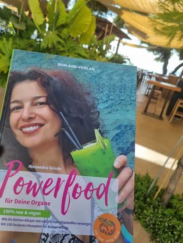 Book cover shows a woman with a green drink in a tropical setting.