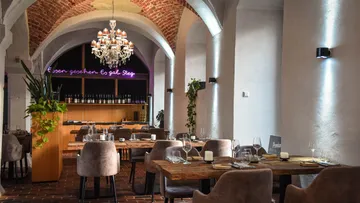 Elegant restaurant with dim lighting and plants.