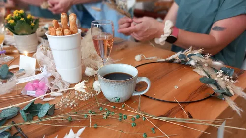 Coffee mug on table while guests make decorations
