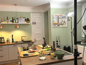 Kitchen with cooking utensils, preparing ingredients in the background.