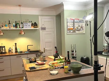 Kitchen with cooking utensils and ingredients to prepare food.