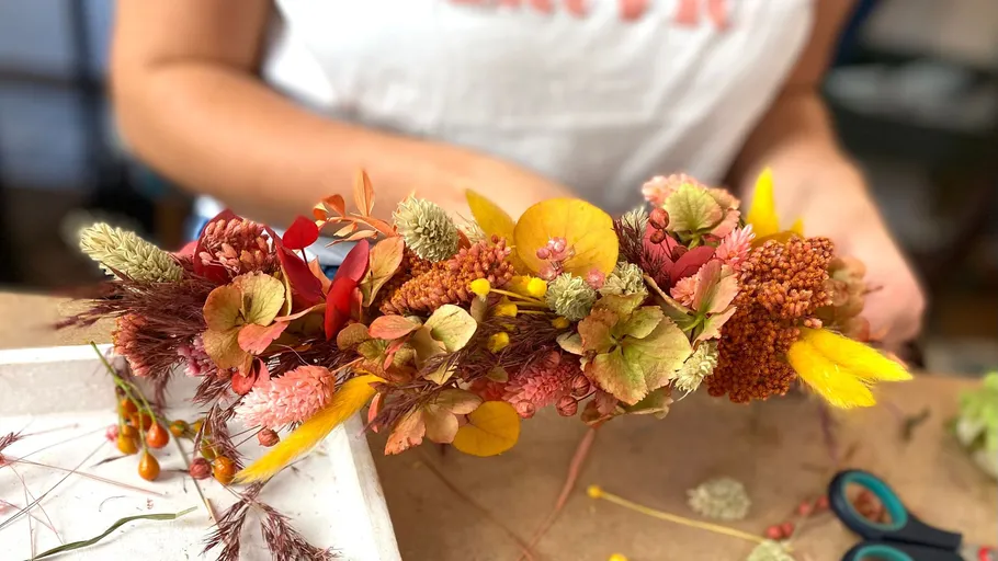 Colourful hair wreath is made surrounded by craft materials.