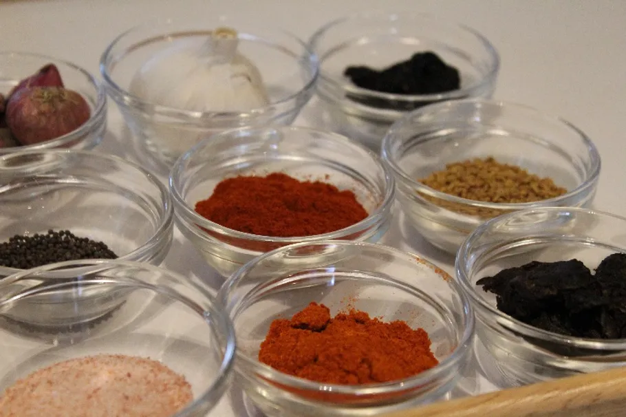 Seasoning in trays, prepared for cooking on the table.