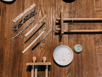 Ribbons and tools lie on a wooden table.
