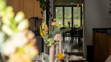 Table decoration is in the foreground, looking at the restaurant interior.