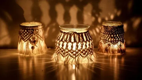 Three illuminated glass lanterns cast decorative shadows on the wall.
