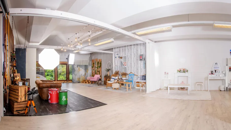 Spacious room furnished with furniture, cameras and lighting.